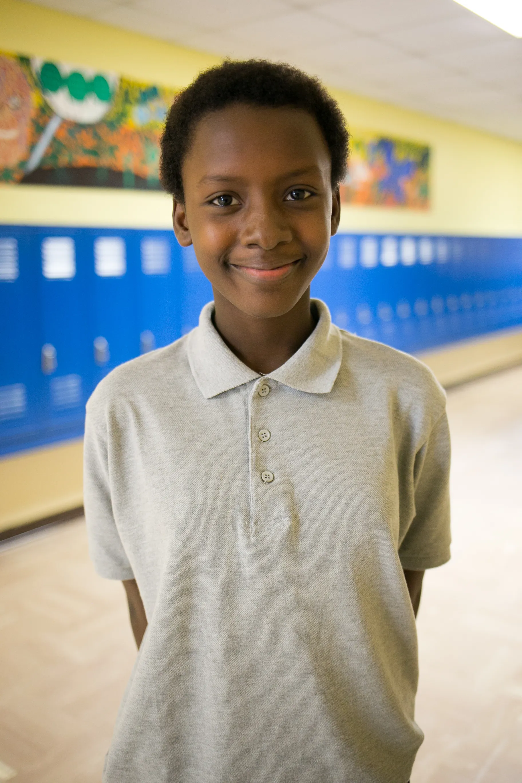 Austin ISD student smiling in school hallway